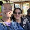 Heather and Rich smile from their seats on a San Francisco cable car