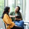 Two women sitting and talking in lobby 