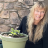 Siobhan Shaw poses next to a potted plant during filming for Growing To Give