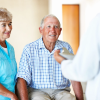 Doctor talking to senior couple