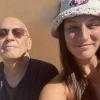 Jeffrey smiles with his daughter in a sunny location