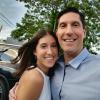 Kayla and her dad smile for an outdoor photograph together