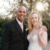 Brandon and Jackie on their wedding day beside a flowering tree